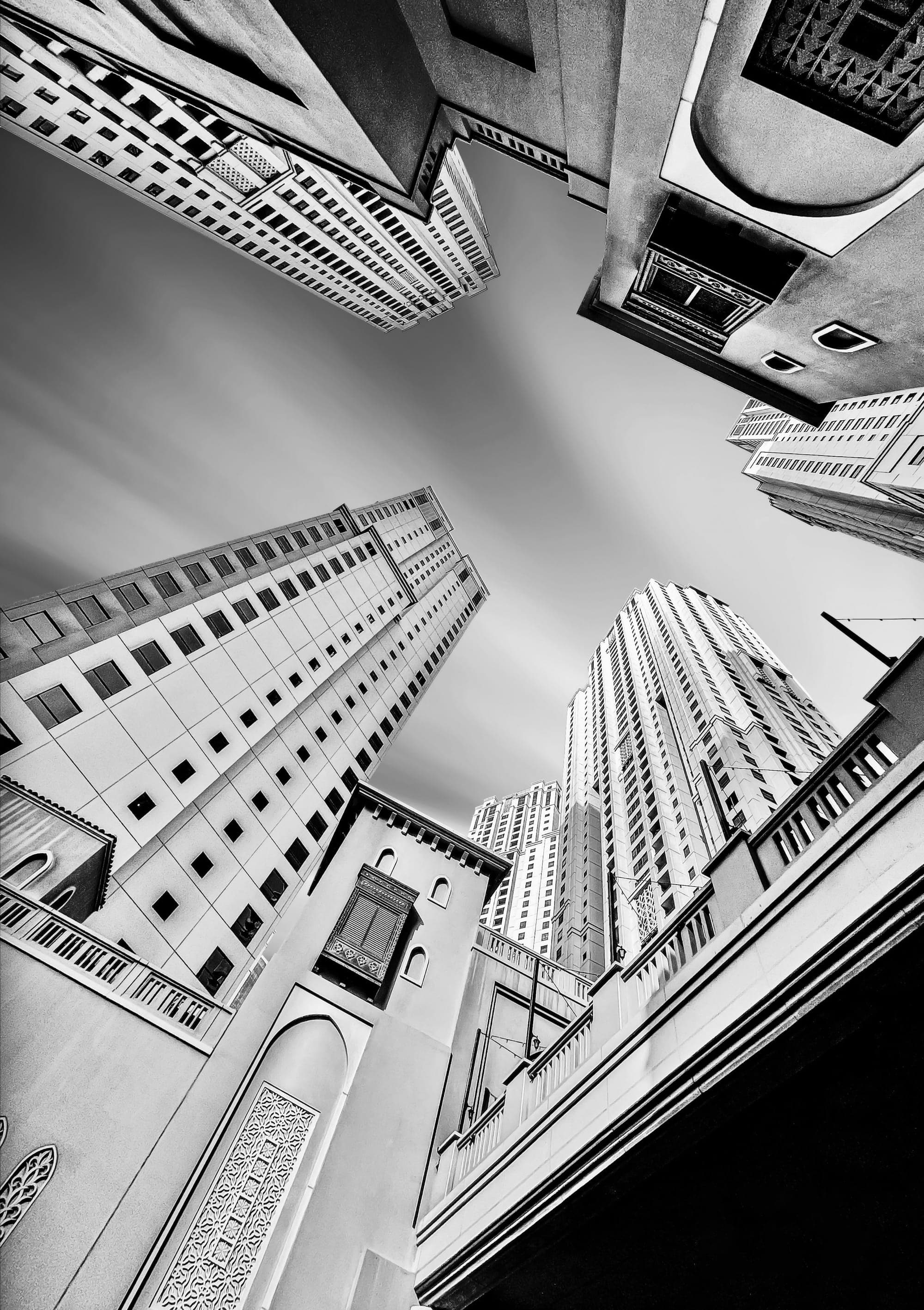 Black-and-white view looking up at residential towers