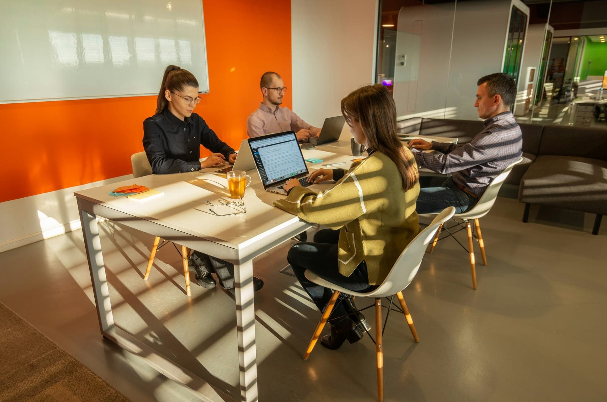 A team working together around a table with laptops